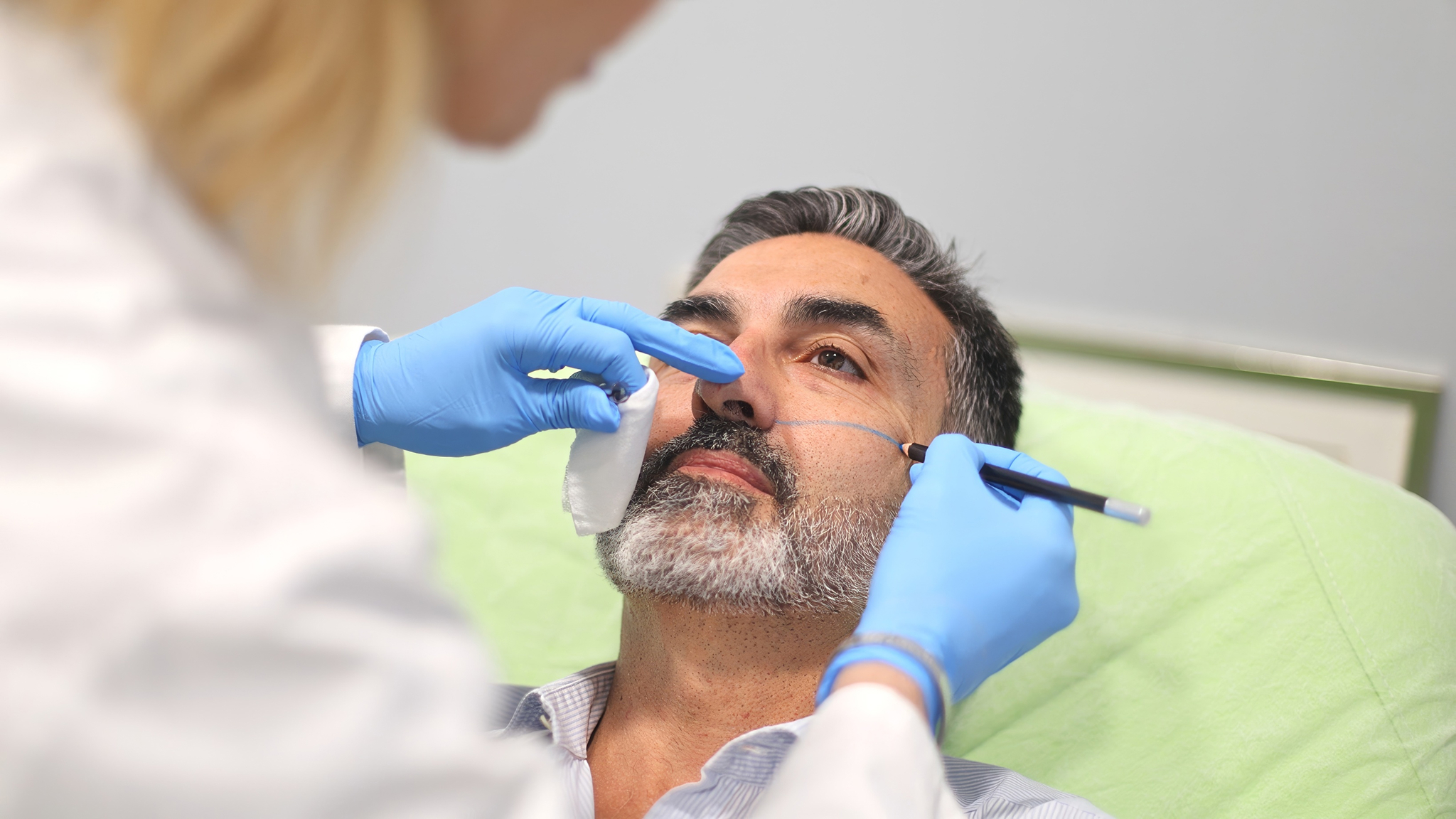 doctor-marking-patient-s-face-for-cosmetic-procedu-2025-03-05-19-00-26-utc 1